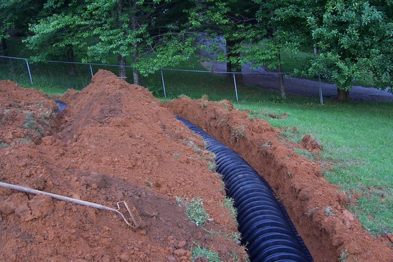Row of plastic leaching chambers set in an excavated trench