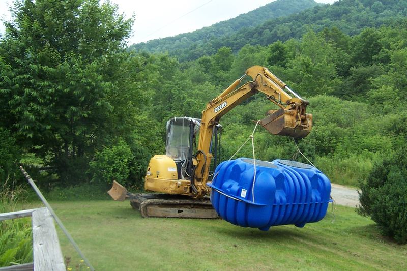 Blue polyethylene septic tank on site ready to be lowered